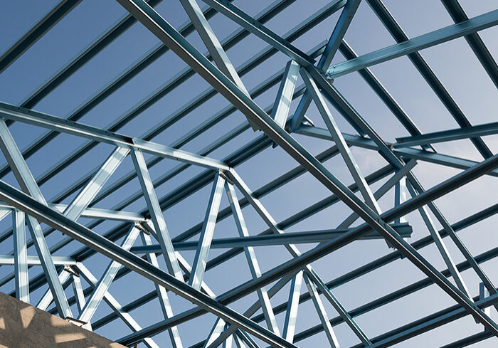 Structure,Of,Steel,Roof,Frame,For,Building,Construction,Isolated,On Structure of steel roof frame for building construction isolated on blue sky background.